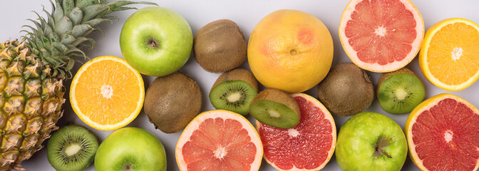 Tropical Fruits on Blue Background Ripe Pineapple Kiwi Oranges Grapefruits Geen Apples Healthy Food Vitamin Diet or Detox Concept Flat Lay Top View Long
