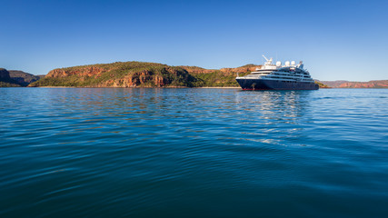 An luxury expedition cruise ship at anchor in the late afternoon in Prince Frederick Harbor on the...