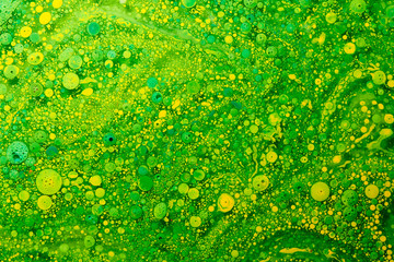 Abstract fluid background geometric circles and chlorophyll bubbles, green and yellow acrylic paints