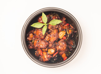 Three cups chicken dish on white