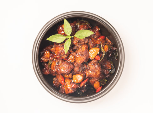 Three cups chicken dish on white