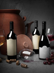 wine bottles mock-up with empty labels for text ongray textured background close up