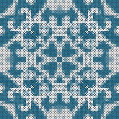 Fototapeta na wymiar Cross stitch pattern with symmetric ornament in blue and white colors. Seamless pattern.