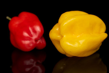 Group of two whole hot chili............... habanero isolated on black glass