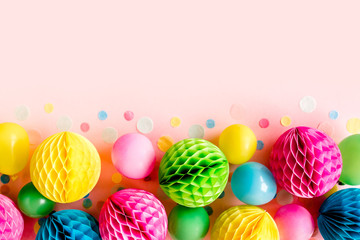 Balloons and confetti on pink background.  Birthday, holiday concept. Flat lay, top view. Birthday party background