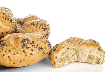 Group of three whole one half of sesame kaiser roll on gray ceramic plate isolated on white background