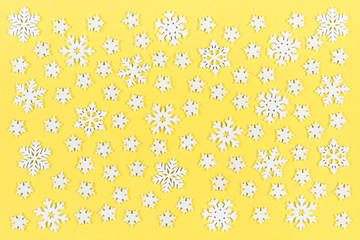Top view of white snowflakes on colorful background. Winter weather concept with copy space. Merry Christmas concept