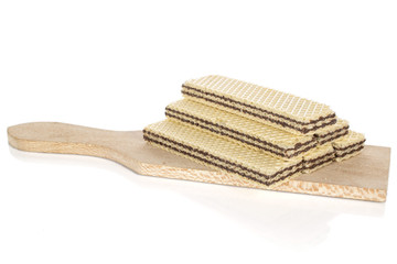 Group of six whole sweet chocolate biscuit wafer on wooden cutting board isolated on white background