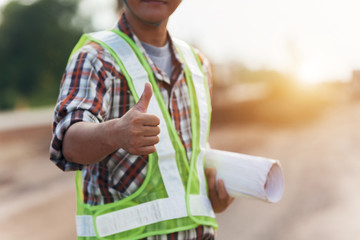 engineer thumbs up, Engineer and worker watching blueprint on construction site