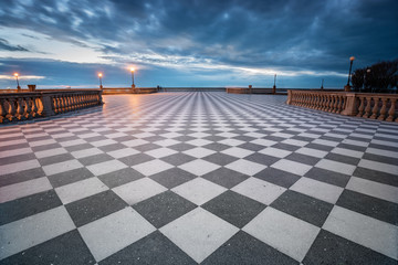 Mascagni terrace with his chessboard pattern floor taken at dusk with a fantastic cloudy sky, Livorno, Italy - obrazy, fototapety, plakaty