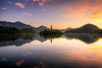 Fototapeta na wymiar Beautiful reflection of Lake Bled and it's surround during sunrise in fall season.