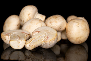 Group of lot of whole two halves of fresh white champignon isolated on black glass