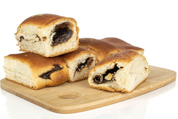 Group of five whole sweet czech bun on bamboo cutting board isolated on white background