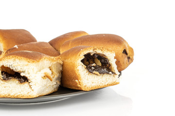 Lot of whole sweet czech bun on gray ceramic plate isolated on white background