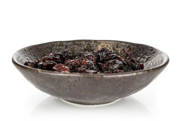 Lot of whole dried cowberry................ in glazed bowl isolated on white background
