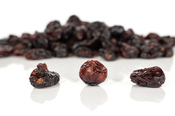 Lot of whole dried cowberry................ three in focus isolated on white background