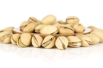 Lot of whole arranged salted pistachio isolated on white background