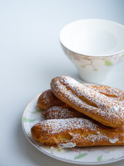 homa made eclairs on a porcelain plate