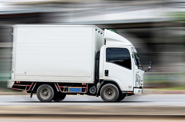 white truck running on the road with speed.