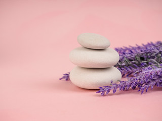 Stack of Zen stones on abstract pink background. Relax still Life with folded stones. Zen pebbles, stones, Spa-calm scenes to slow life. with vegetation, ecological concept