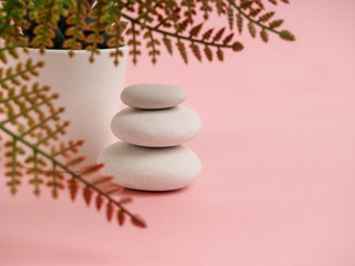 Stack of Zen stones on abstract pink background. Relax still Life with folded stones. Zen pebbles, stones, Spa-calm scenes to slow life the soul of the imperturbable tranquility of the concept.