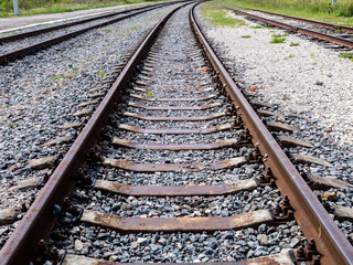 Fototapeta premium Long empty railroad tracks go into the distance, travel concept