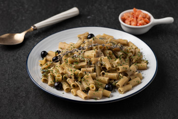 pasta with blueberry and dry shrimp on black background