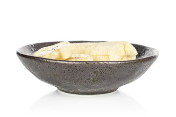 Group of three slices one piece of sweet yellow banana in glazed bowl isolated on white background