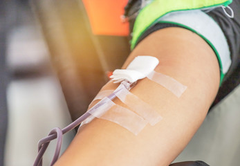 needle syringe injecting in to the arm to blood donor during transfusion blood donation unit in laboratory  the hospital.