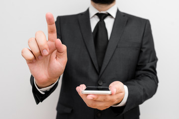 Male human wear formal work suit hold smart hi tech smartphone use one hand