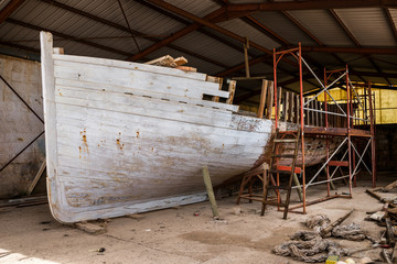 an old lobster fishing boat restoration in workshop