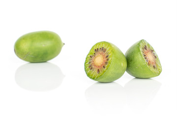 Group of one whole two halves of hardy green kiwi isolated on white background