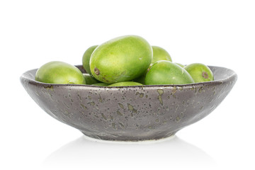 Lot of whole hardy green kiwi in glazed bowl isolated on white background