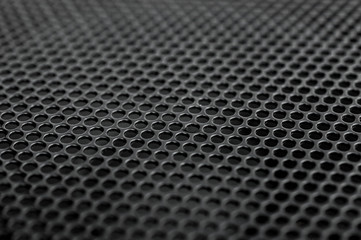 Black metal grid on audio speaker. Audio speaker texture. Macrophoto. Abstract background.