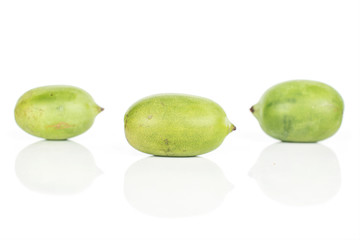 Group of three whole hardy green kiwi isolated on white background