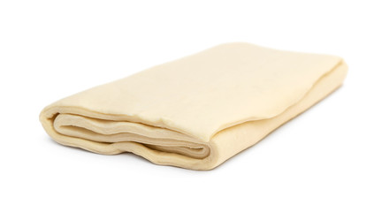 Folded raw puff dough on white.