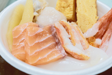 Sushi Donburi or Japanese rice bowl topped with fresh seafood sashimi at fish market