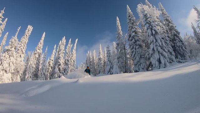 SLOW MO: elite professional sport rider for a snowmobile ride in the fabulous snow-covered mountain taiga. bright snowmobile and suit. snowmobilers sports riding. stock video footage