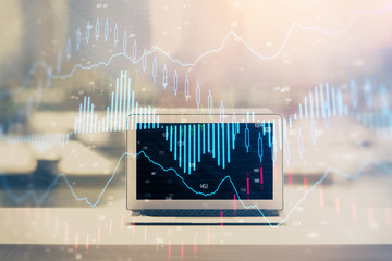 Stock market graph on background with desk and personal computer. Double exposure. Concept of financial analysis.