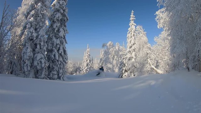 SLOW MO: elite professional sport rider for a snowmobile ride in the fabulous snow-covered mountain taiga. bright snowmobile and suit. snowmobilers sports riding. stock video footage
