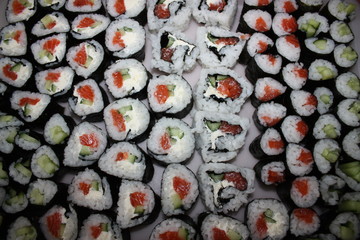 Background, texture, still life of sushi from different ingredients throughout the photo field.