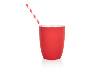One whole paper straw with red ceramic cup isolated on white background