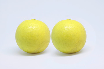 Two whole lemon isolated on white background
