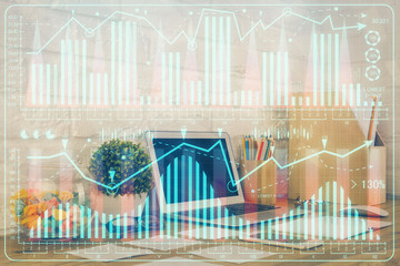 Double exposure of chart and financial info and work space with computer background. Concept of international online trading.