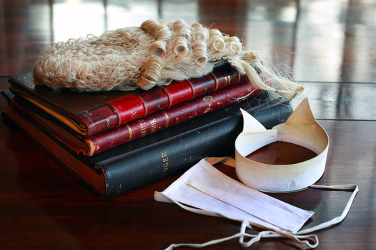 barrister's wig and collar with books on table