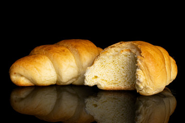Group of one whole one half of sweet golden mini croissant isolated on black glass