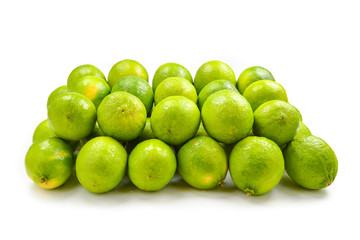 Many fresh limes on white background.