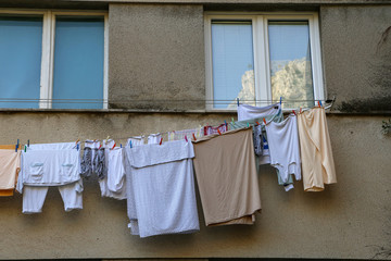 Laundry dries under the windows of a high-rise building