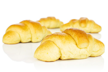 Group of four whole sweet golden mini croissant isolated on white background