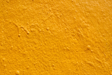 closeup of yellow painting on the wall texture